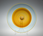 swirled orange glass disc